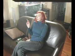 Sexy Redhead On Leather Couch Smoking A Cigarette