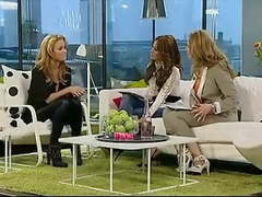 Blonde woman wearing shiny leather pants and high heel boots