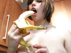 Louisa sucks off a banana wearing yellow lingerie in the kitchen