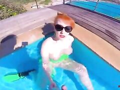 Horny redhead MILF fucks herself in the pool